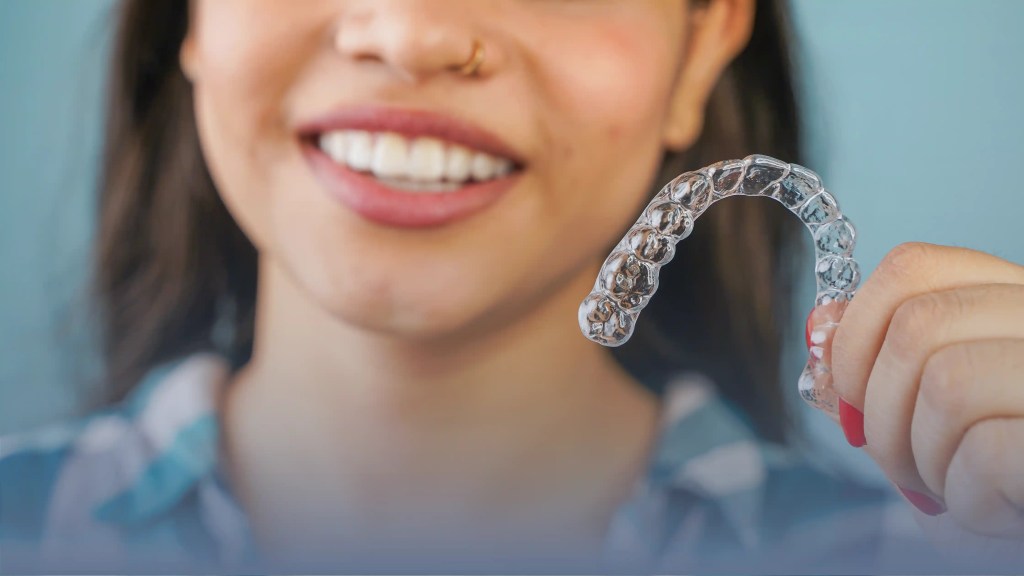 A woman showing off her clear aligners
